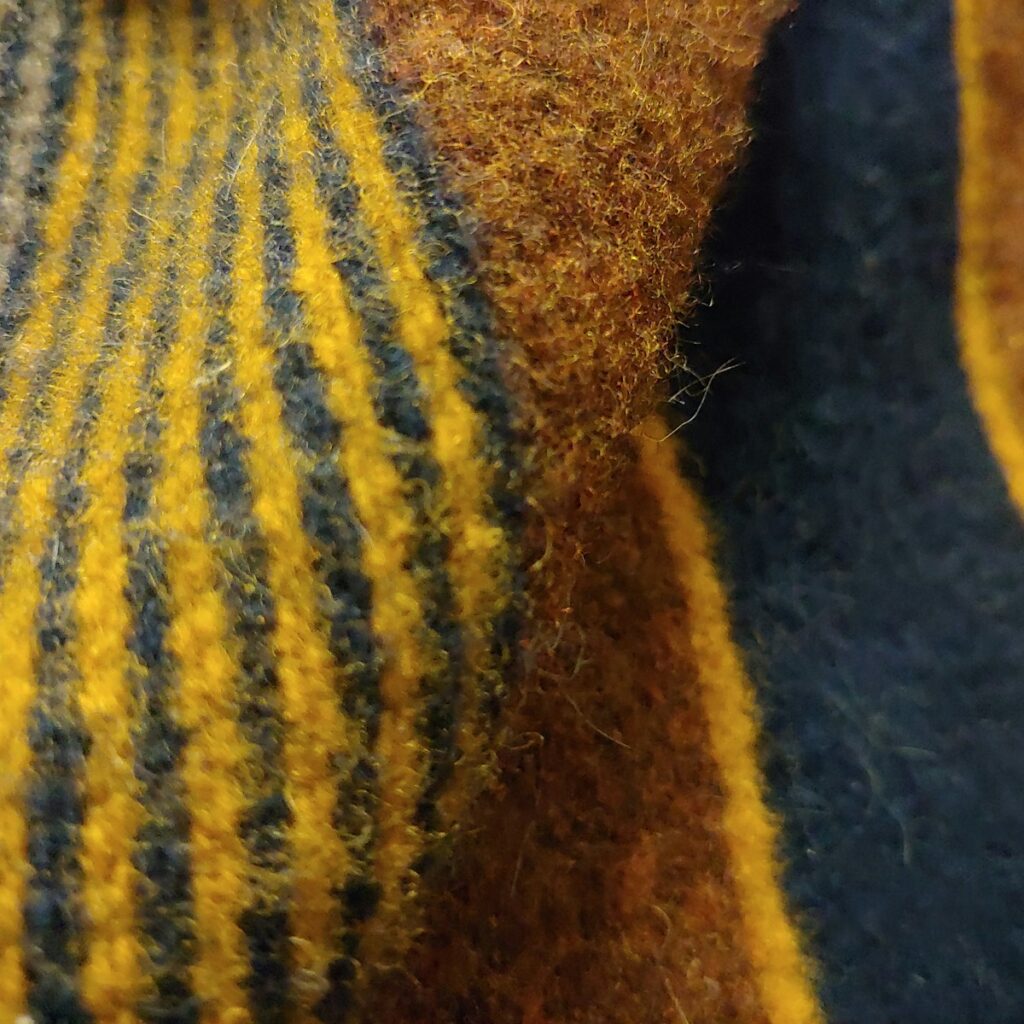 a close up of a yellow and blue sweater